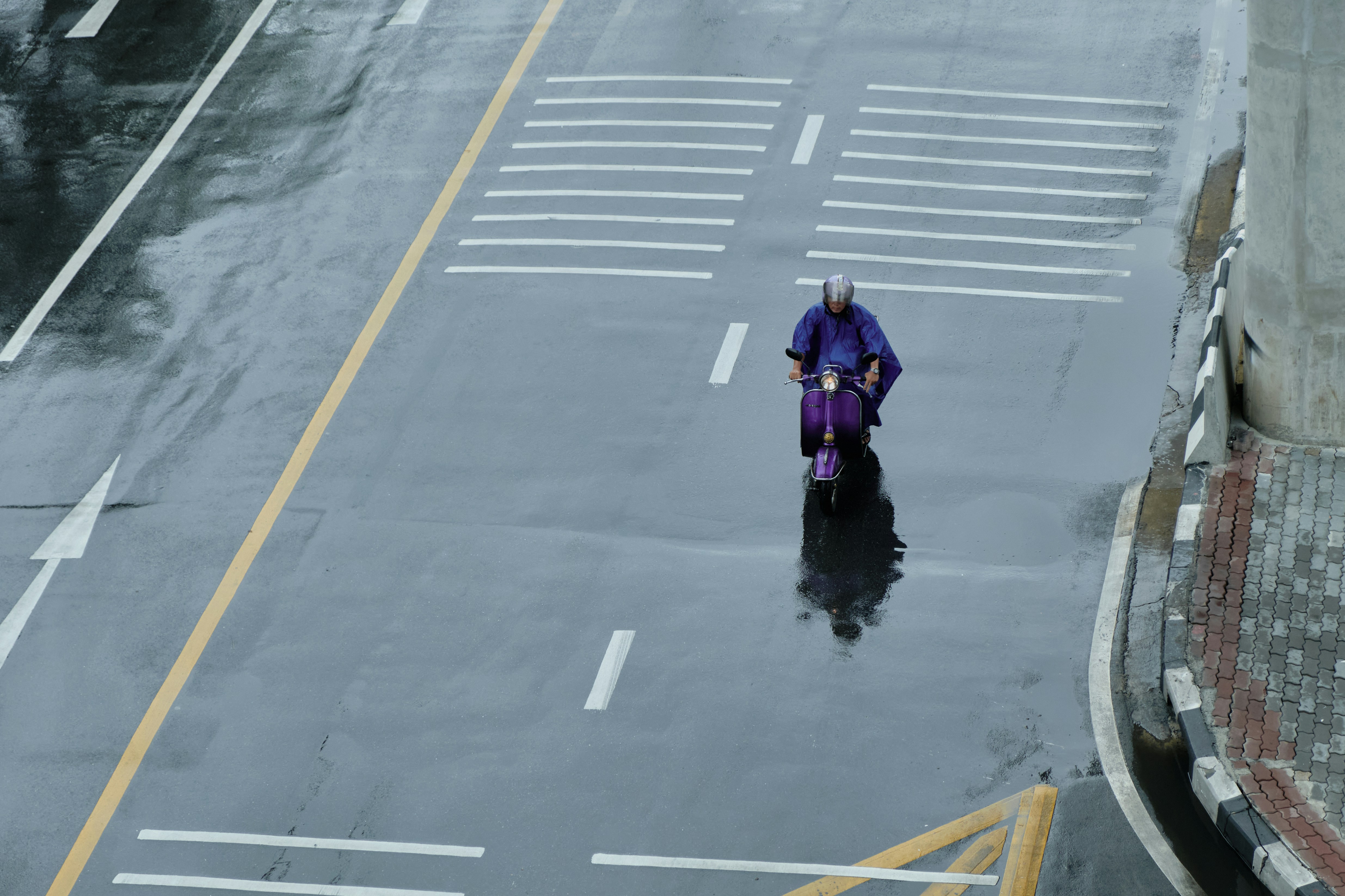 a person and a child riding a bike down a street