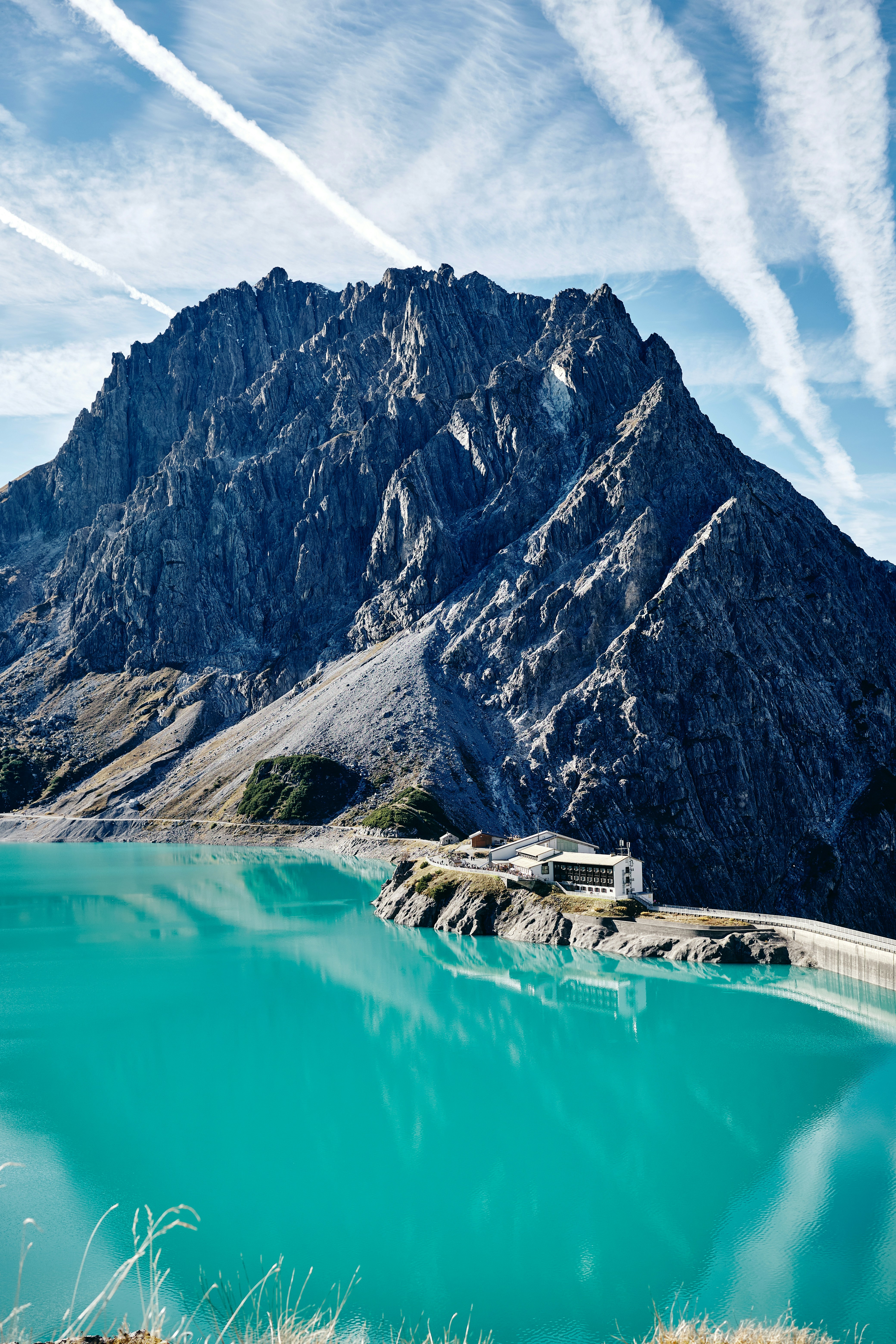 a building on a cliff by a body of water
