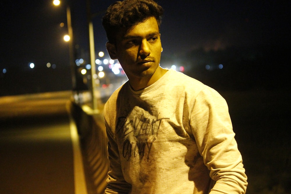 a man standing on a street at night