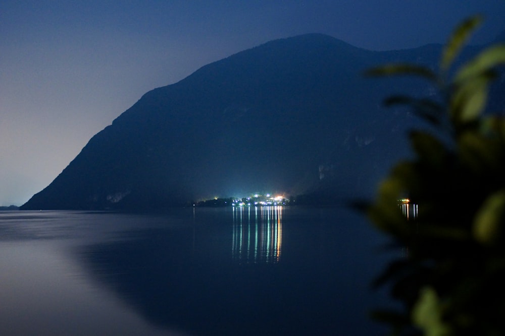 a body of water with a mountain in the background