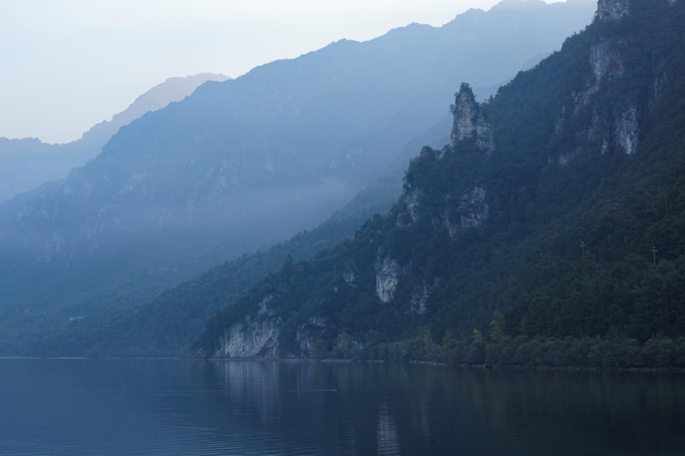 a body of water with mountains in the back