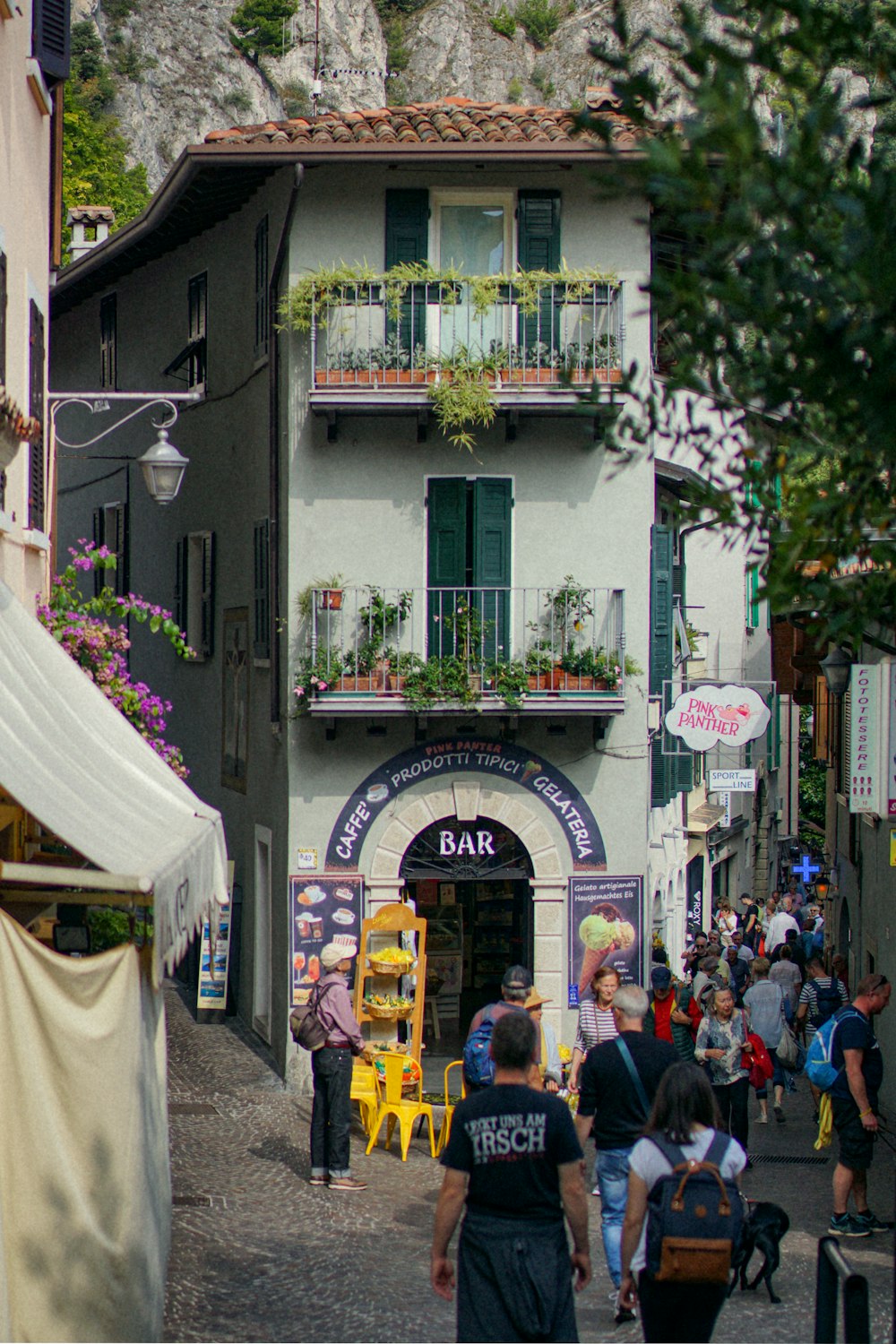 a group of people walking through a narrow street