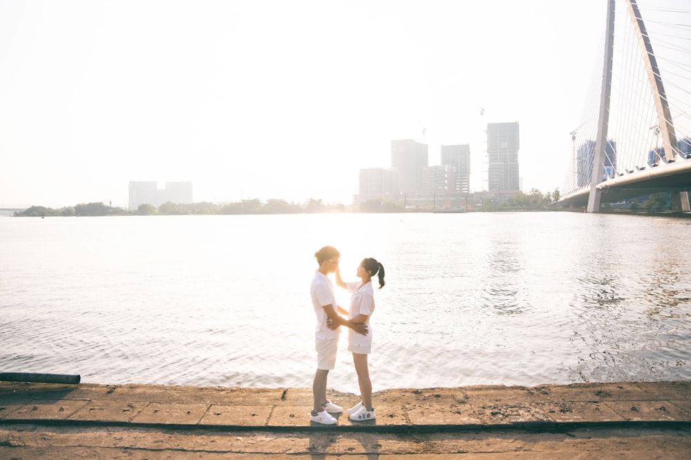 two people standing on a dock