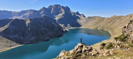 a person standing on a rock in a lake