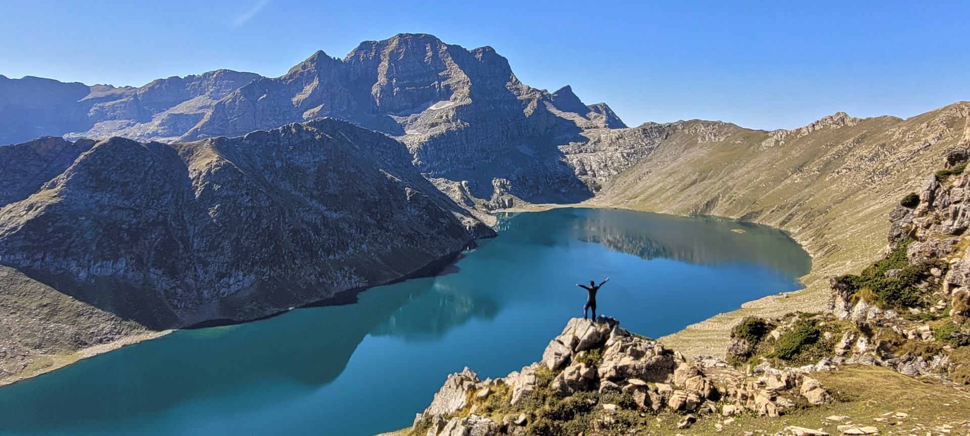a person standing on a rock in a lake