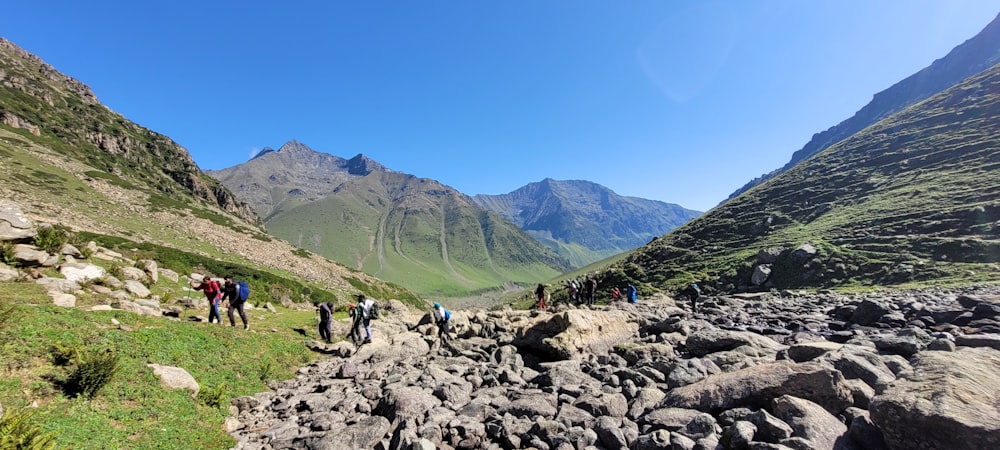 a group of people hiking in a valley