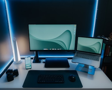a desk with a laptop and a monitor
