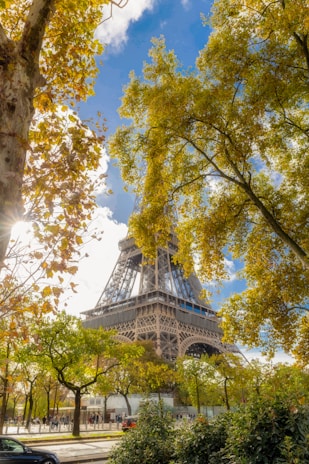 An iconic landmark framed by colorful flowers and a bright, sunny day.