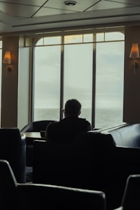 A calm and focused person reflecting in a cozy, bright room.