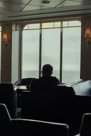 A serene person sitting peacefully in a cozy room, reflecting calm and clarity.