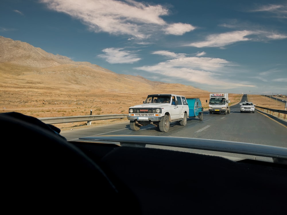 a group of vehicles driving on a highway