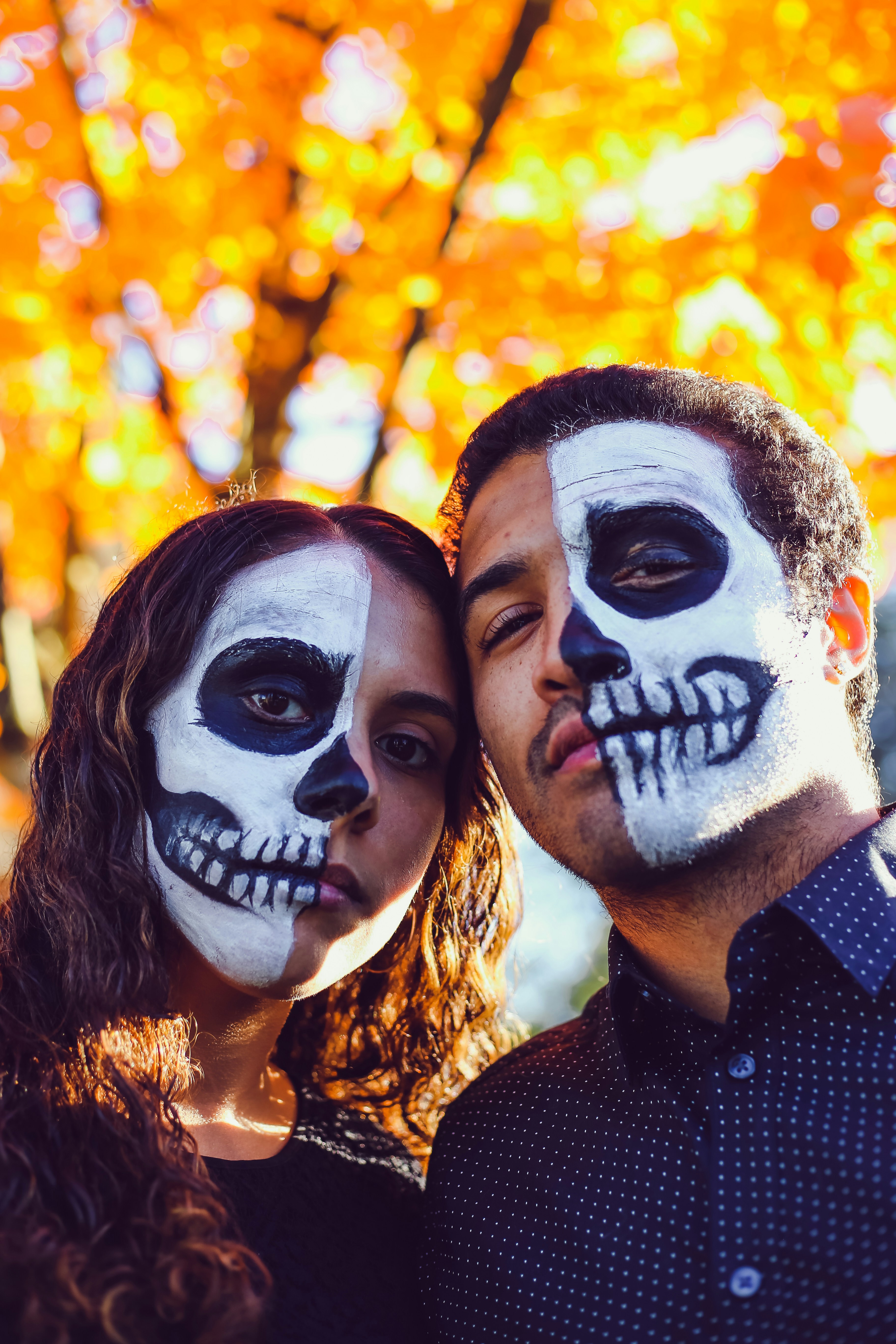 a man and woman with face paint
