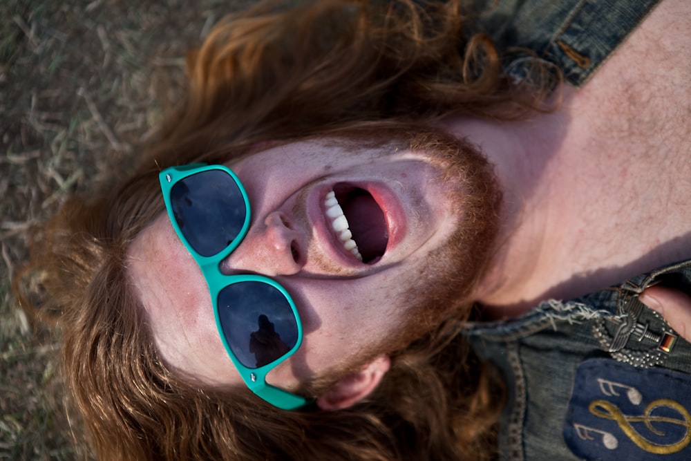 a man wearing green sunglasses