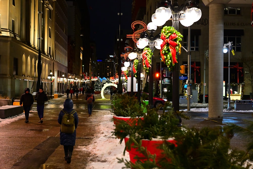 people walking on a street with lights