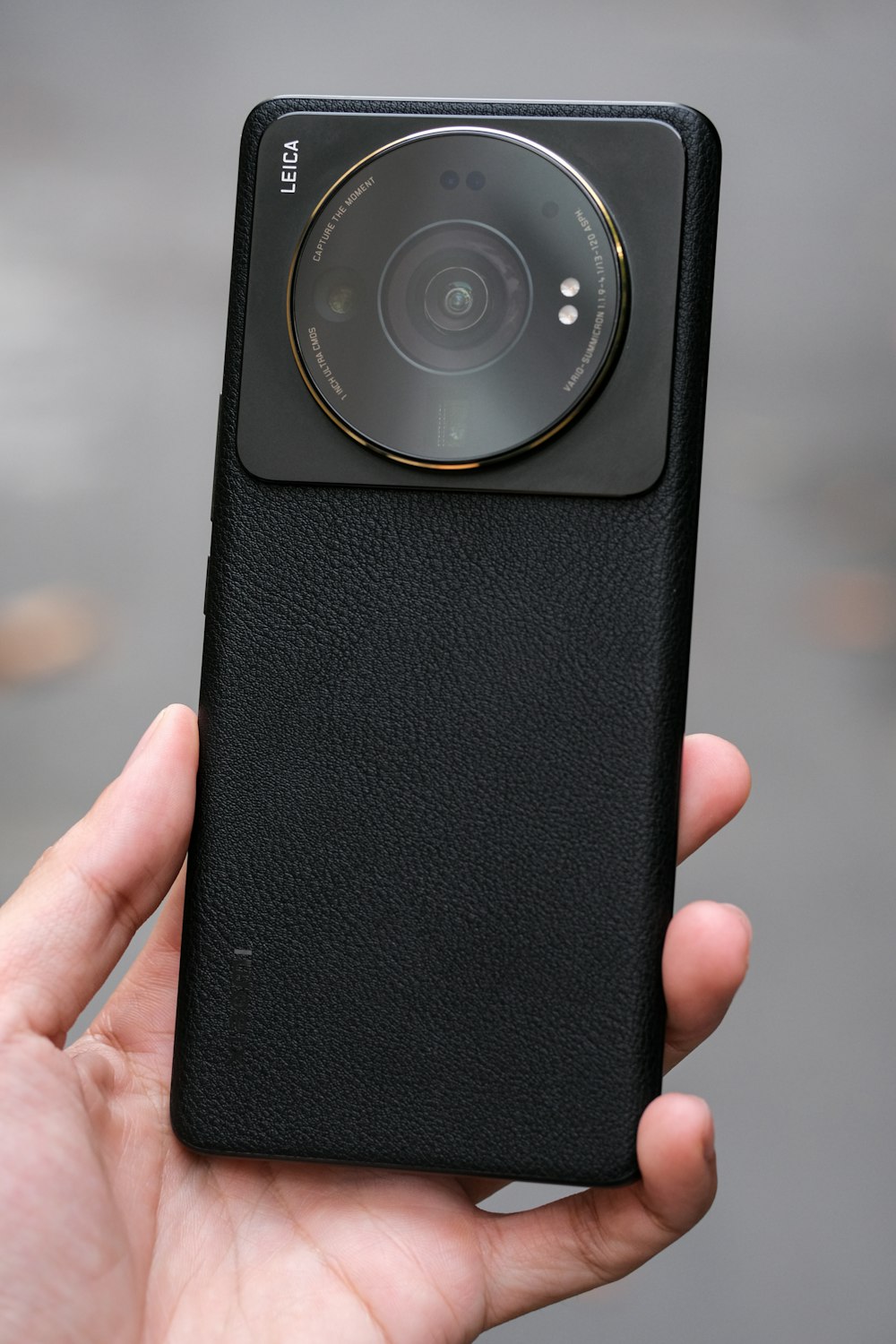 a hand holding a black rectangular object