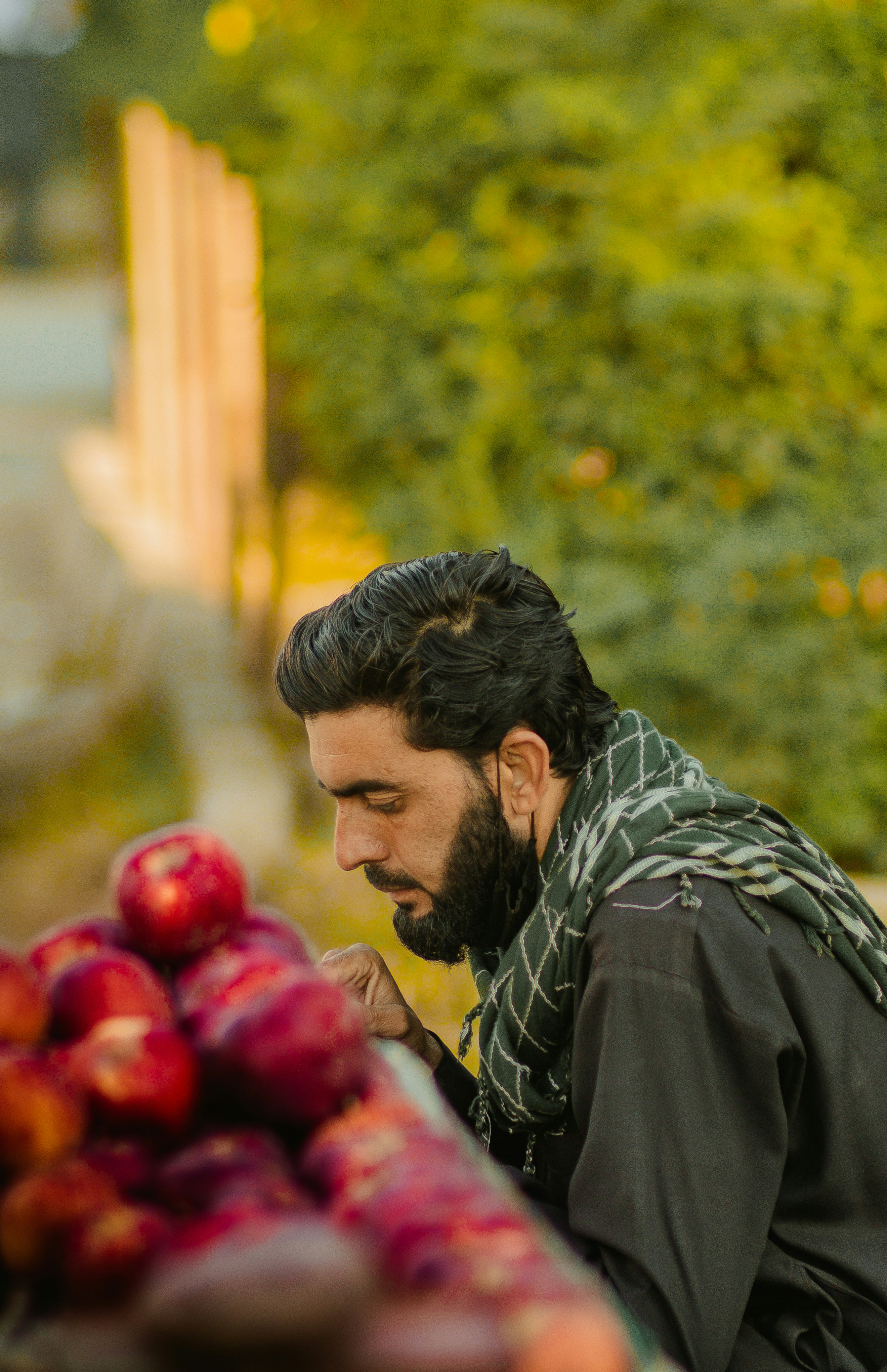 a man looking at a bunch of fruit