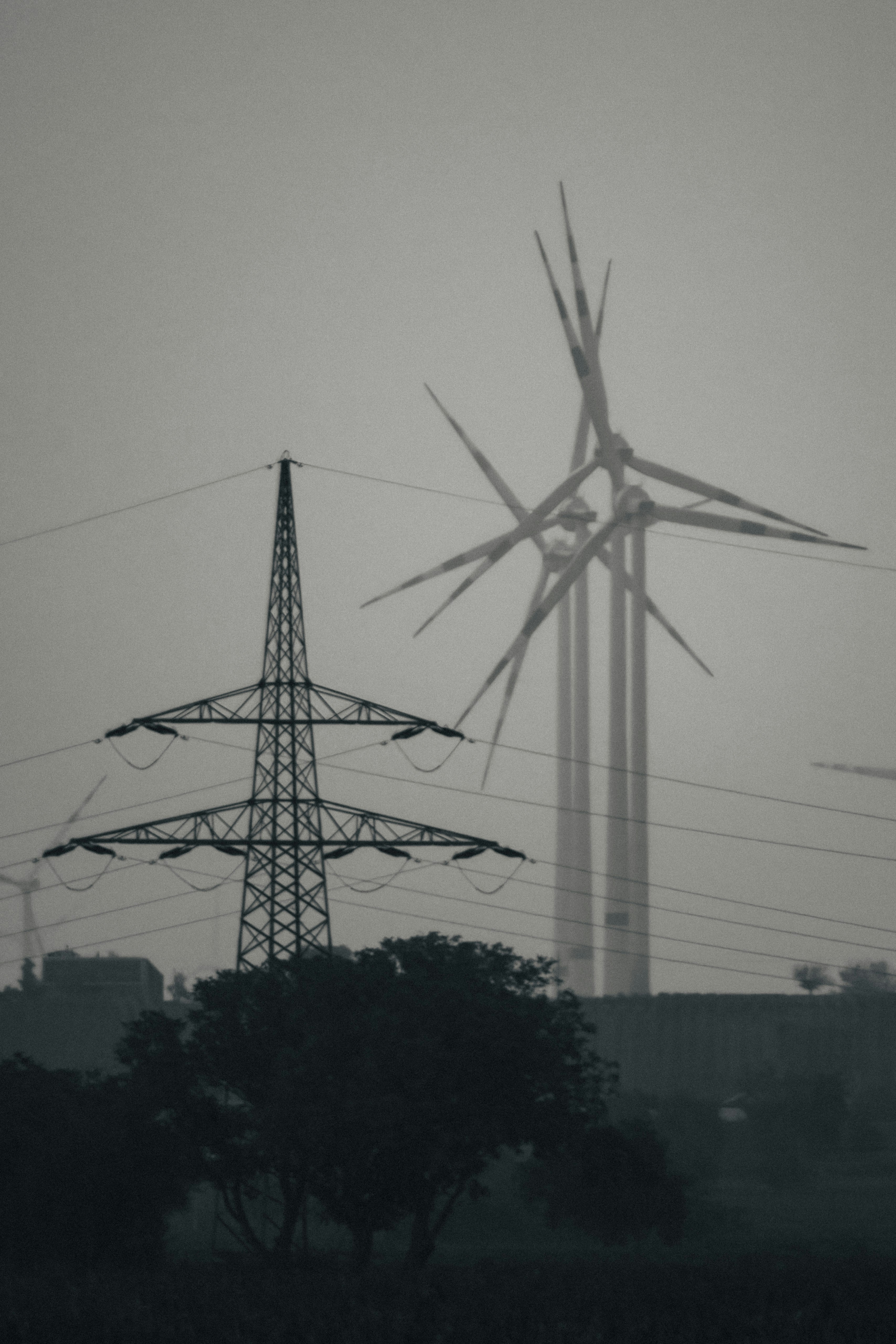 a large windmill next to a tree