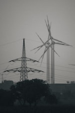 a large windmill next to a tree