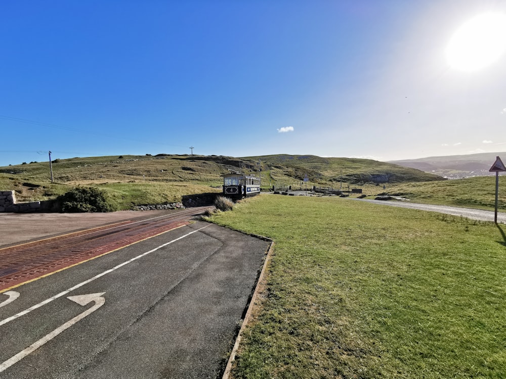 a road with grass and a truck on it