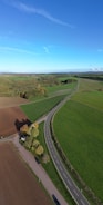 a road with grass and trees on the side