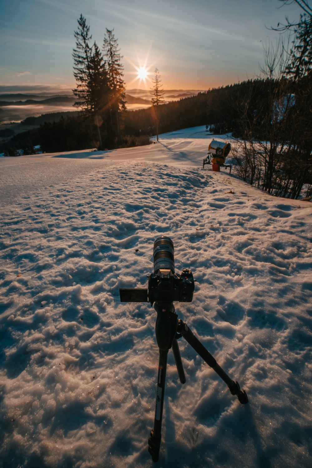 a camera on a tripod in the snow