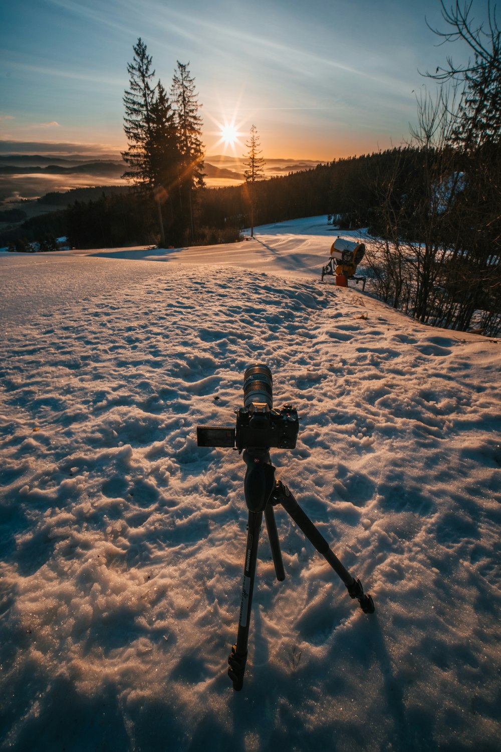 a camera on a tripod in the snow