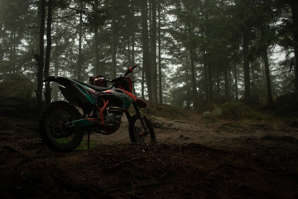 a dirt bike parked in a forest