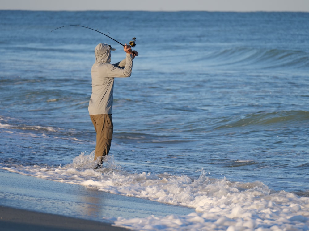 a man playing golf on the beach