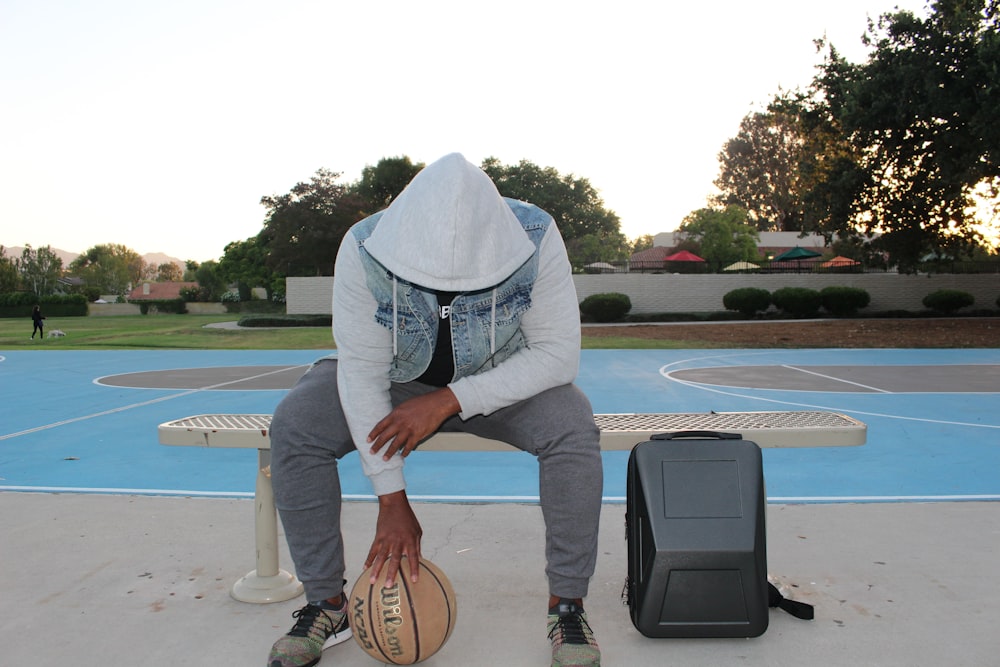 a person sitting on a bench with a guitar and a drum