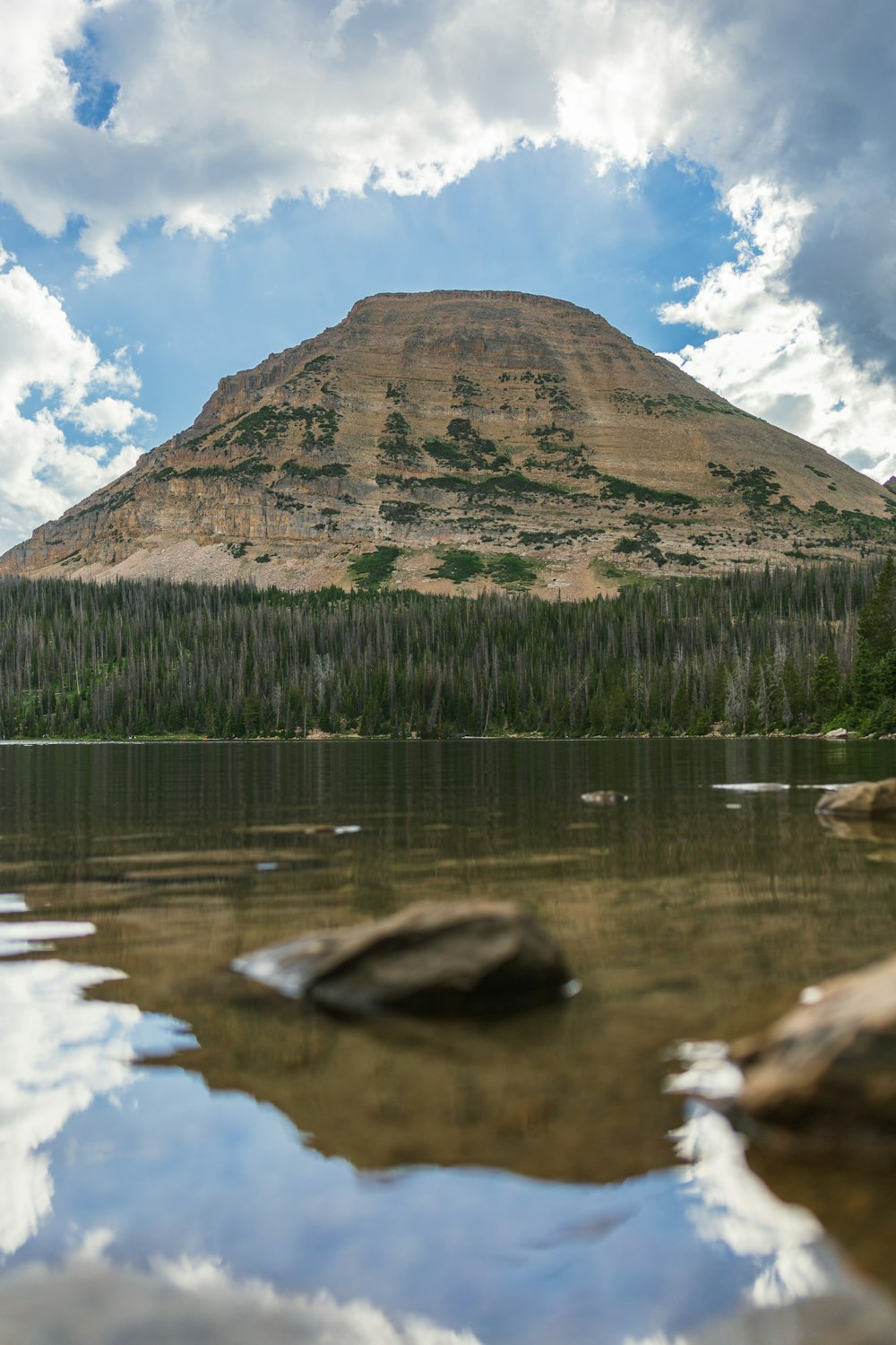 a large mountain behind a body of water