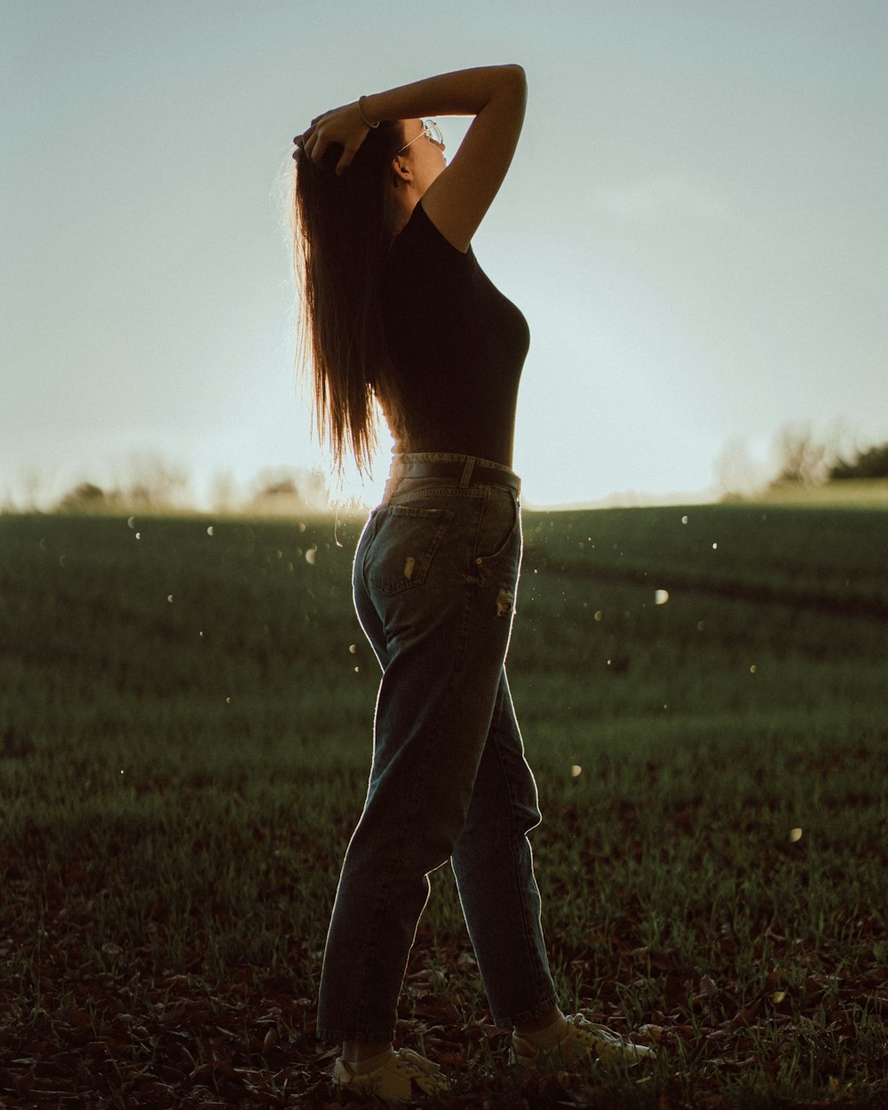 a woman standing in a field