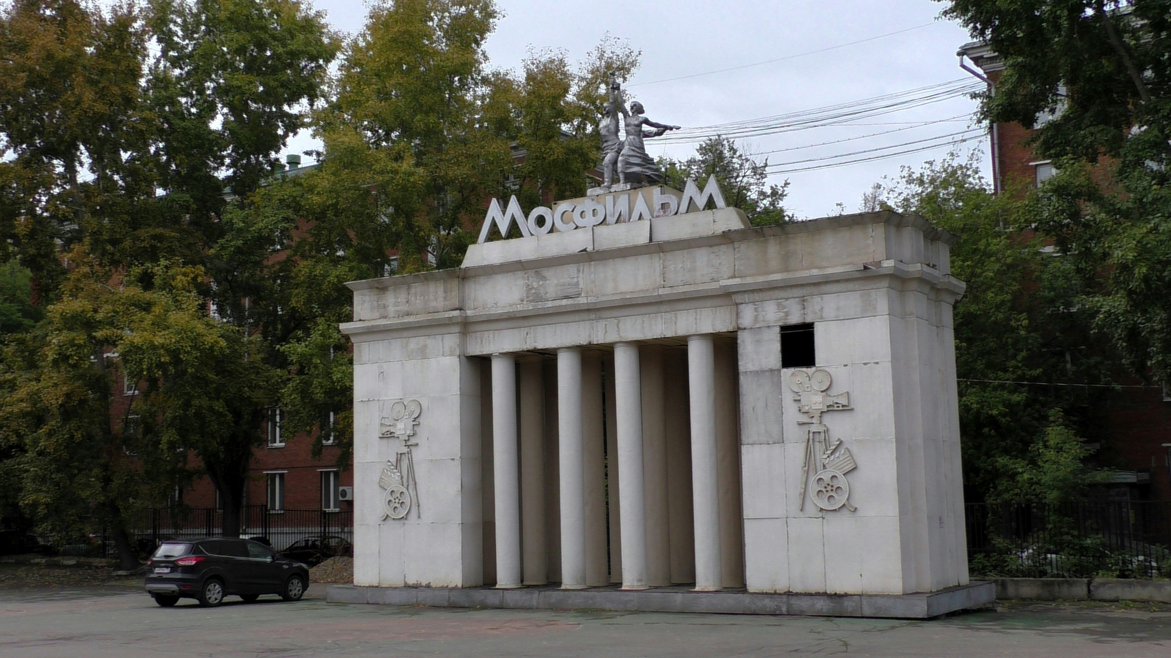 a white building with a statue on top