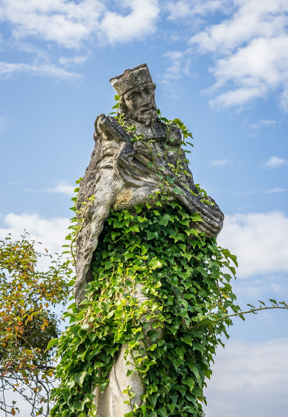 a tree with a statue on top