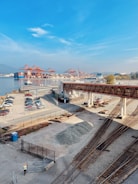a train track with cars and a bridge over it
