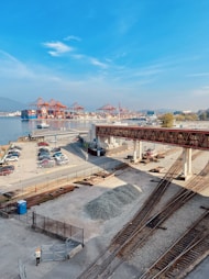 a train track with cars and a bridge over it