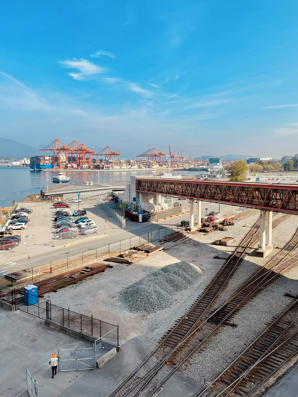 a train track with cars and a bridge over it