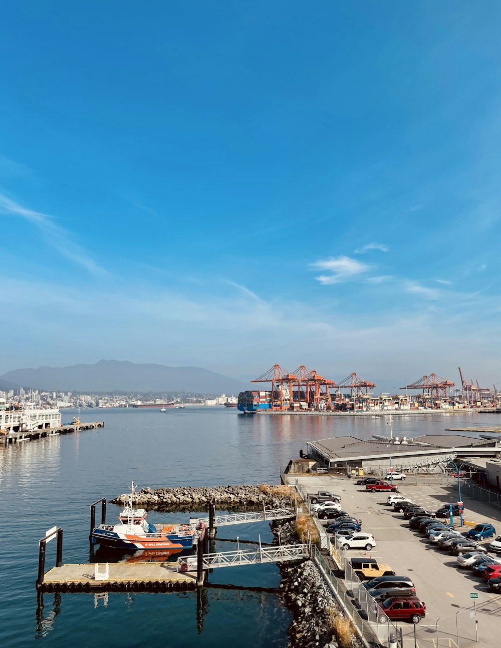 a dock with boats and cars