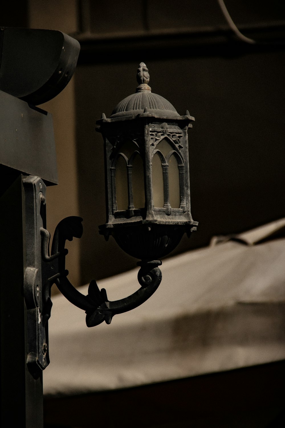 a black and white photo of a bell and a lamp