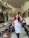 A cheerful restaurant owner standing in front of a beautifully styled dining area.