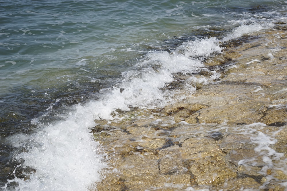 a rocky beach with waves crashing