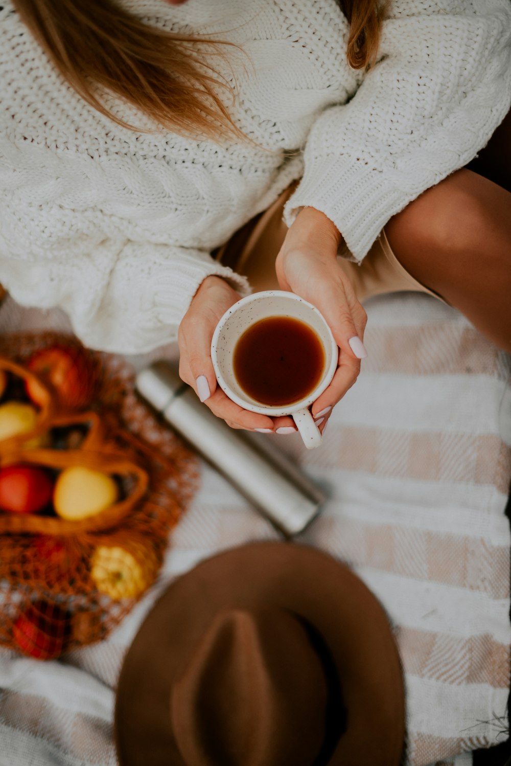 a person holding a cup of tea