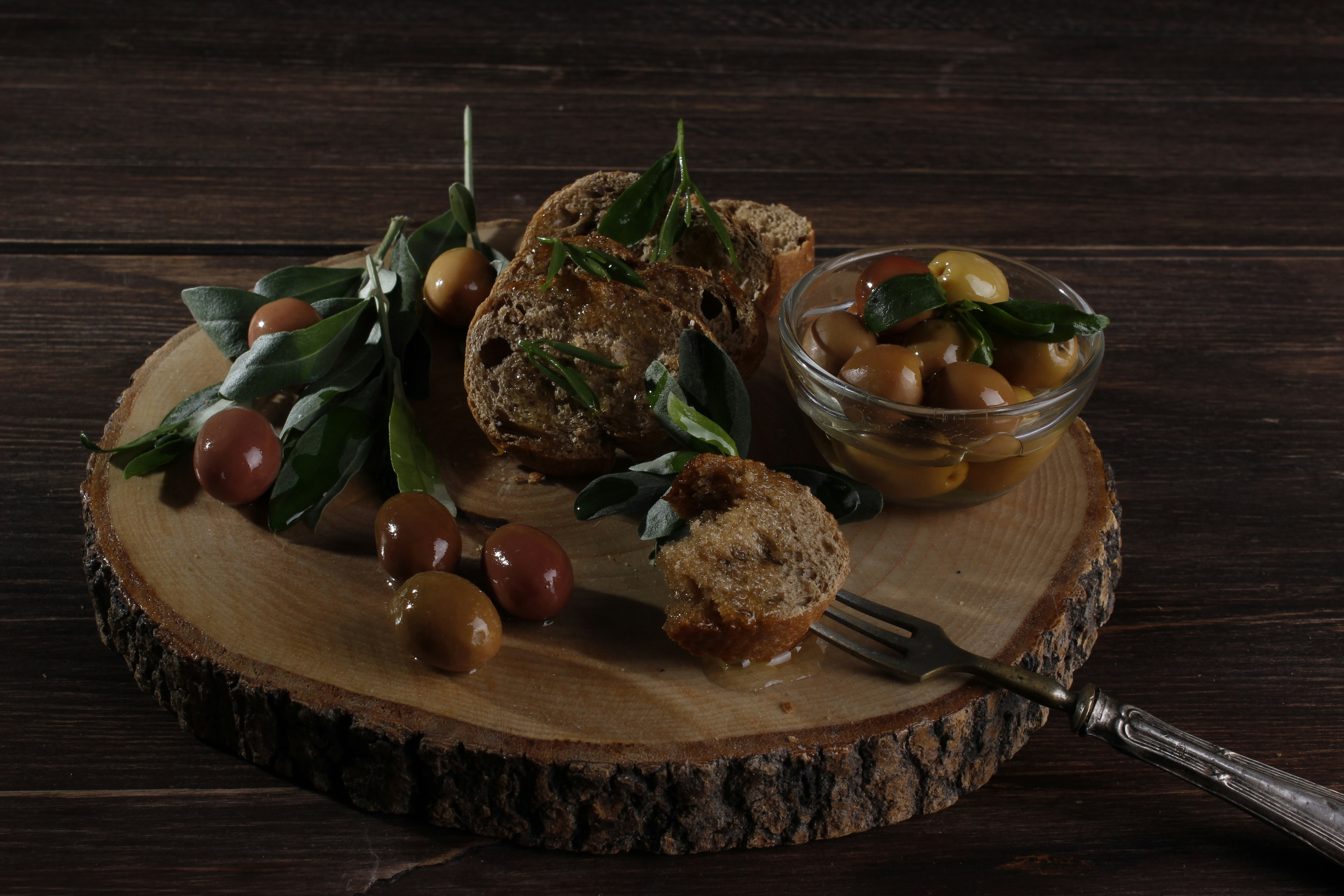 Antipasto on a wooden slab with olives