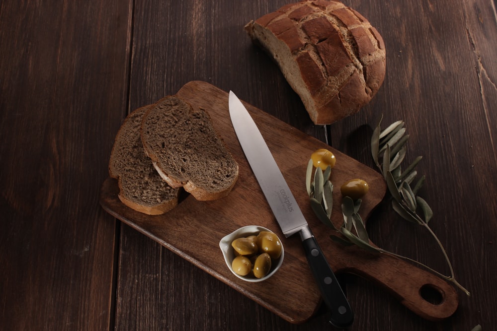 a cutting board with bread and a knife on it