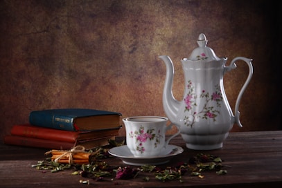 a teapot and books on a table