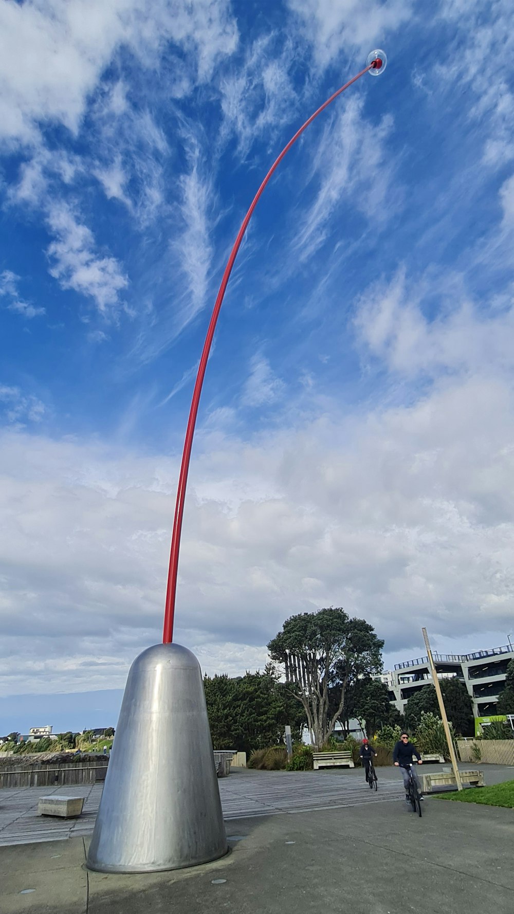 a large red and white object with a person riding a bike