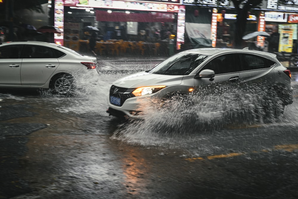 cars driving through a flooded street