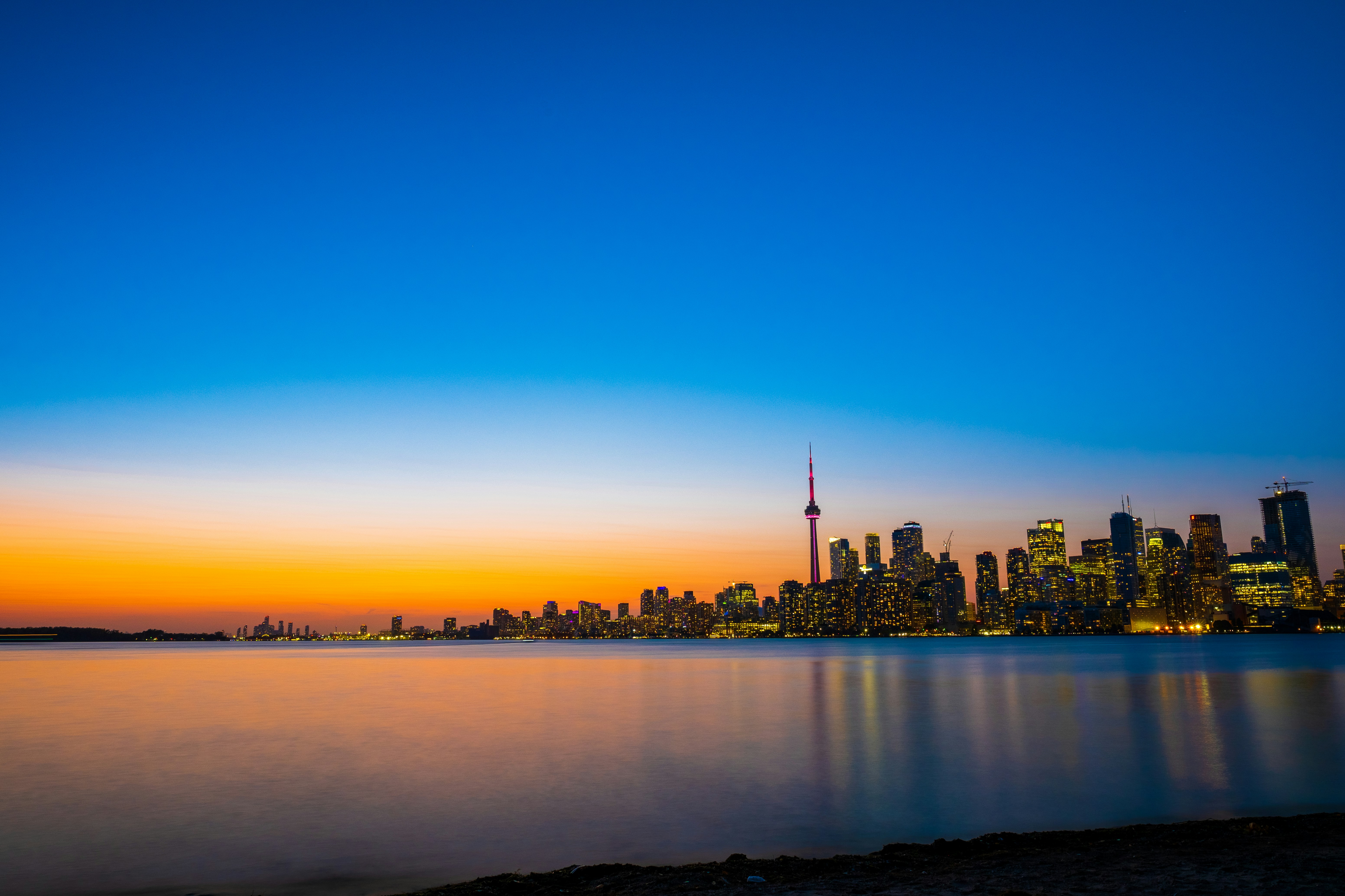 A U.S. city skyline seen across the water at sunset