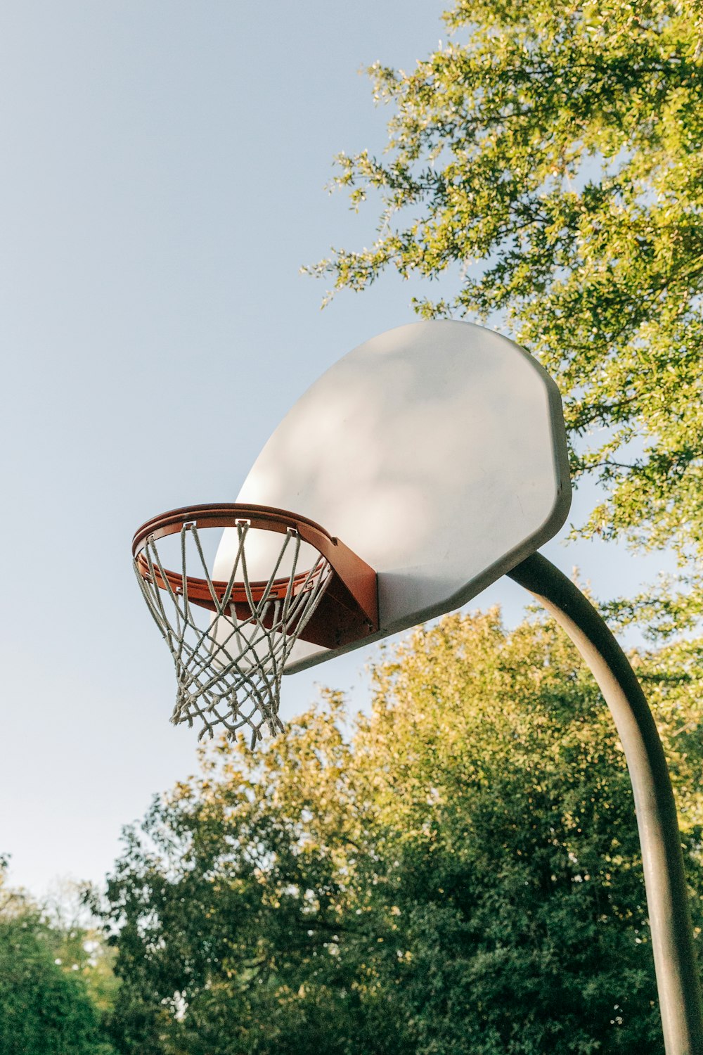 a basketball hoop with trees in the background