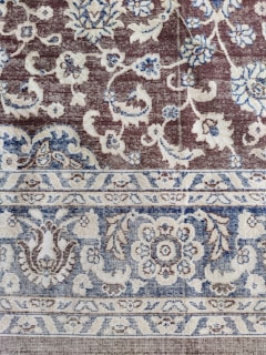 Traditional handwoven carpet with floral motifs and warm earth colors