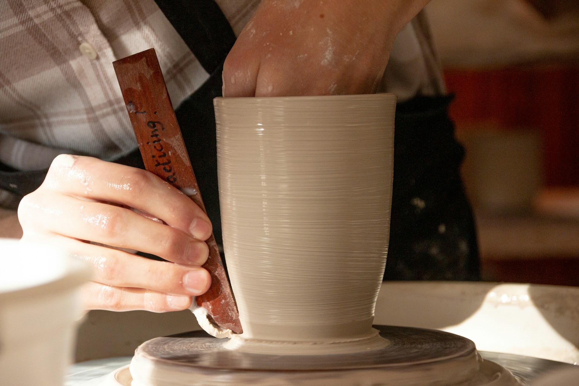 a person pouring a liquid into a cup
